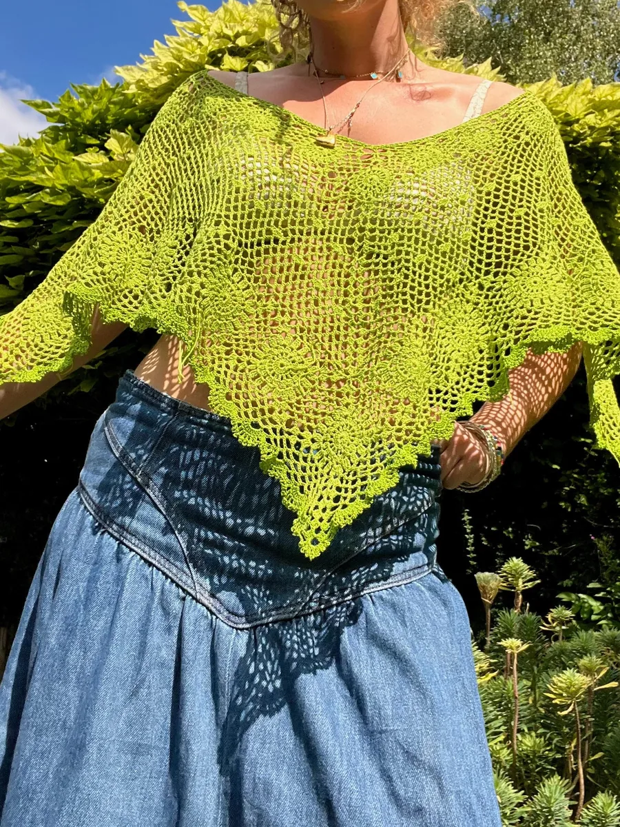 Close view of the Clover Poncho's floral lace and scalloped hem