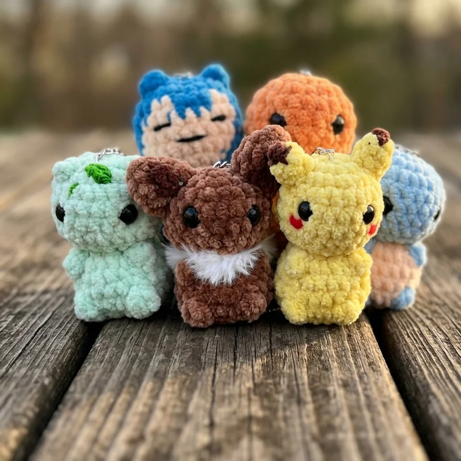 Six colorful plush crochet characters clustered together outdoors
