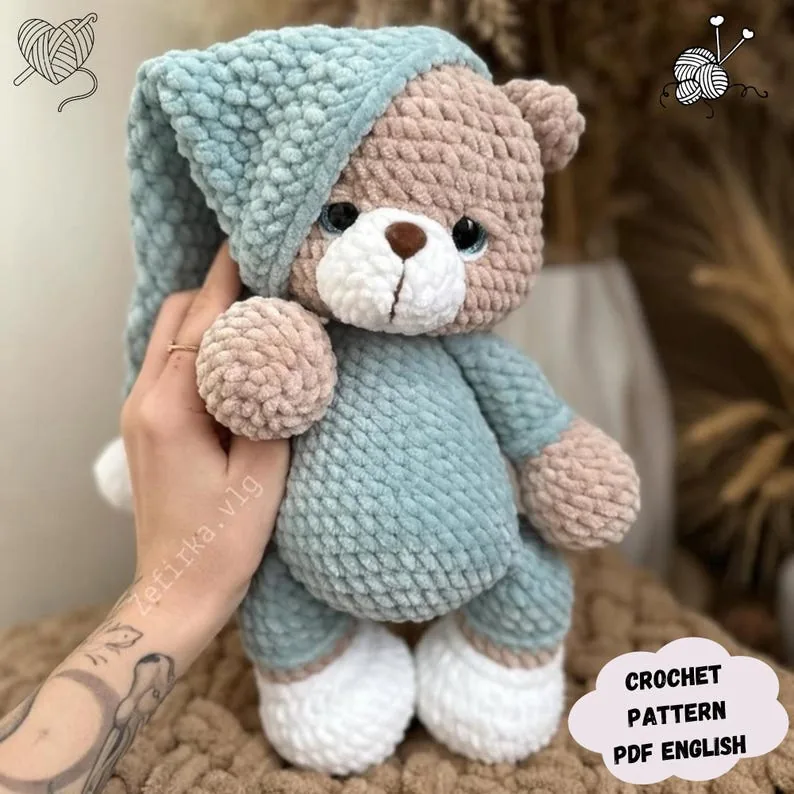 Blue crochet teddy bear in pajamas and a sleeping cap