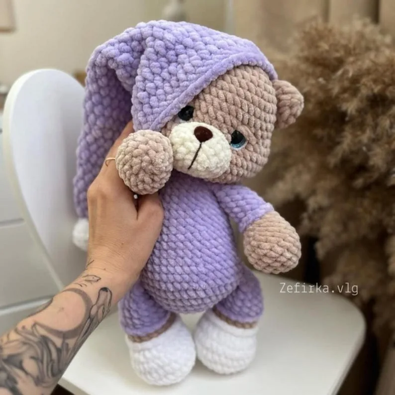 Lavender plush crochet bear with a matching bedtime cap